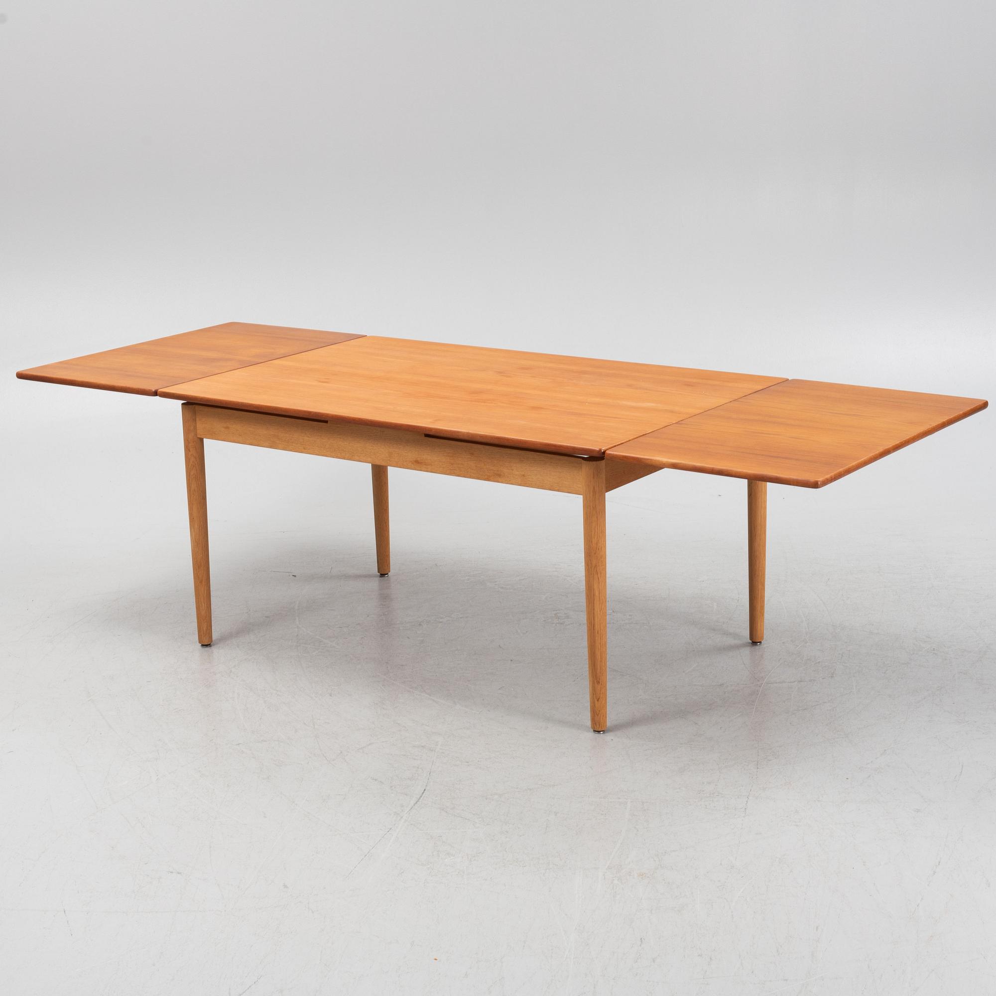 Hans J. Wegner, an oak and teak dinner table for Andreas Tuck. Denmark.