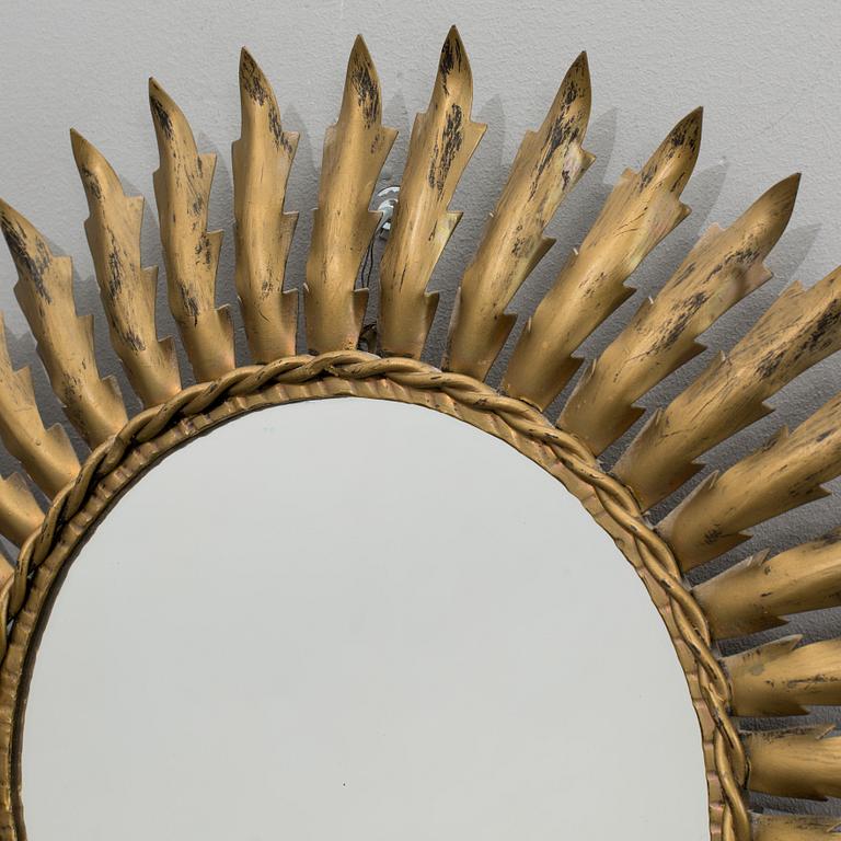 A 20th century metal sun mirror.