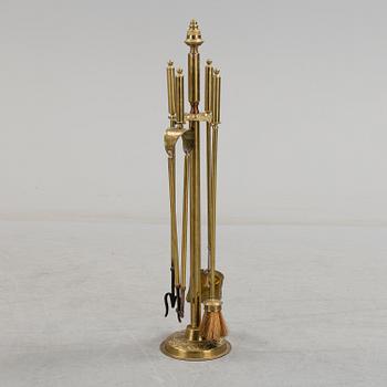 A set of 4 brass fire utensils with stand, 20th Century.