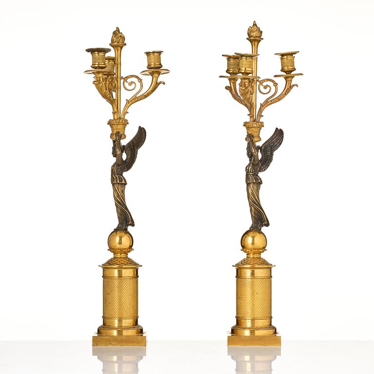 A pair of Empire ormolu three-light candelabra, early 19th century.