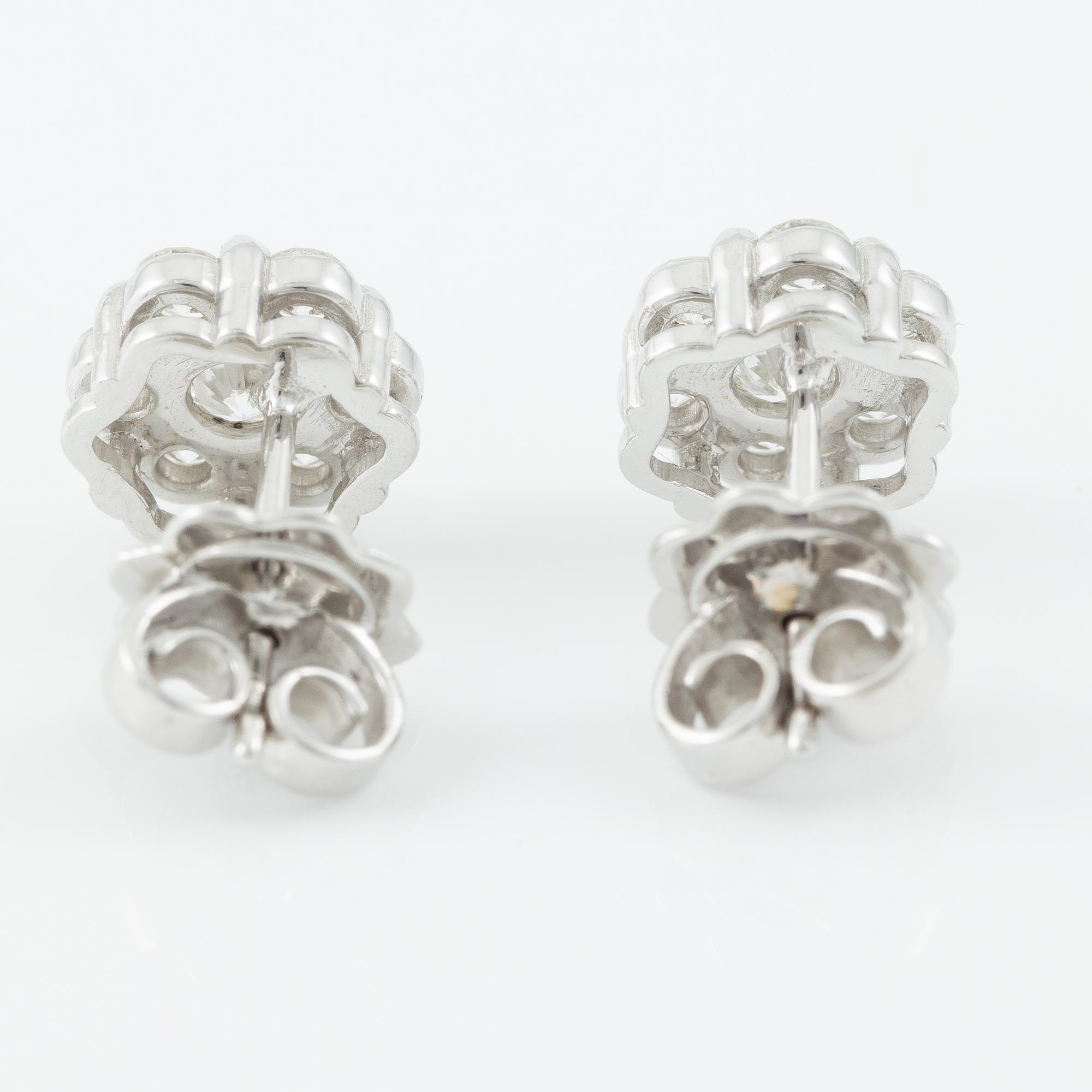 A pair of earrings in 18K white gold set with round brilliant-cut diamonds.