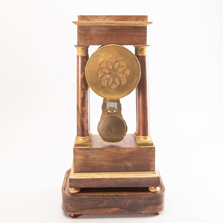 A late Empire mid 19th century veneered table clock.