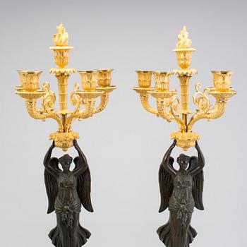 A large pair of first half of the 19th century gilt and patinated bronze five-light candelabra.