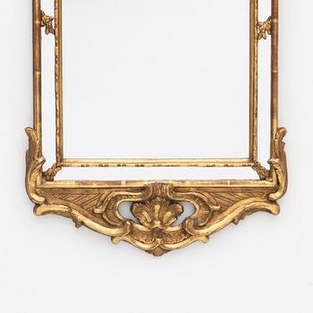 A Rococo style mirror, circa 1900.