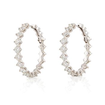 565. A pair of earrings in 18K white gold set with round brilliant-cut diamonds.