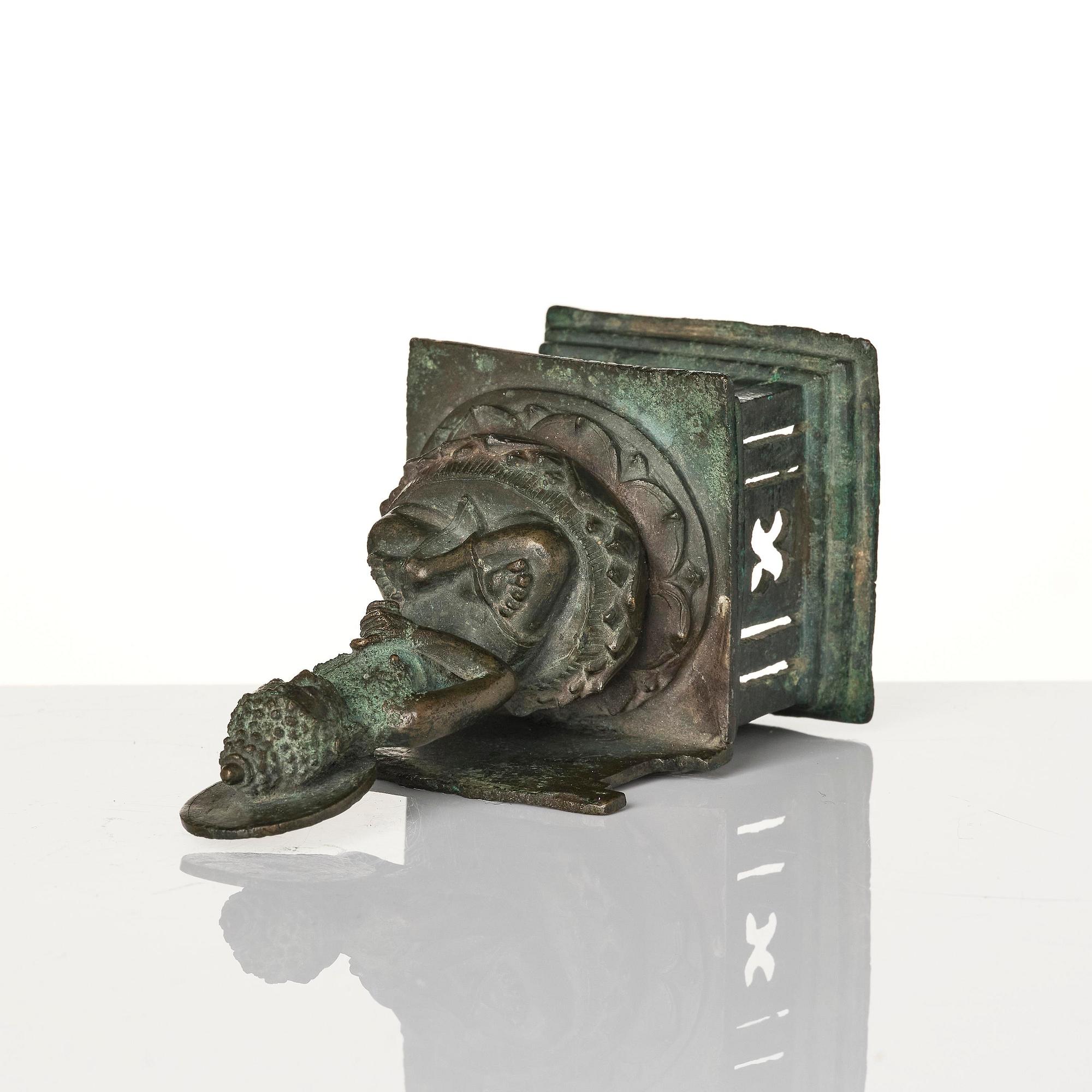 A bronze Buddha Vairocana, Eastern Java, 10th century.