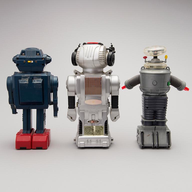 Three Vintage Toy Robots and a Table Clock.