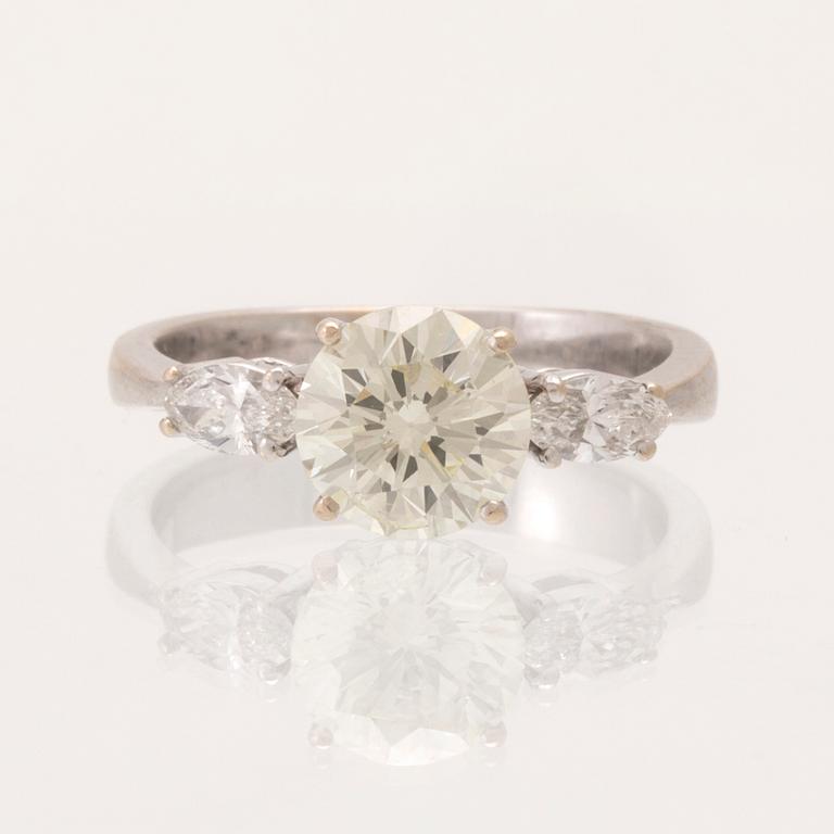 An 18K white gold ring set with one round brilliant-cut diamond and two marquise-cut diamonds.