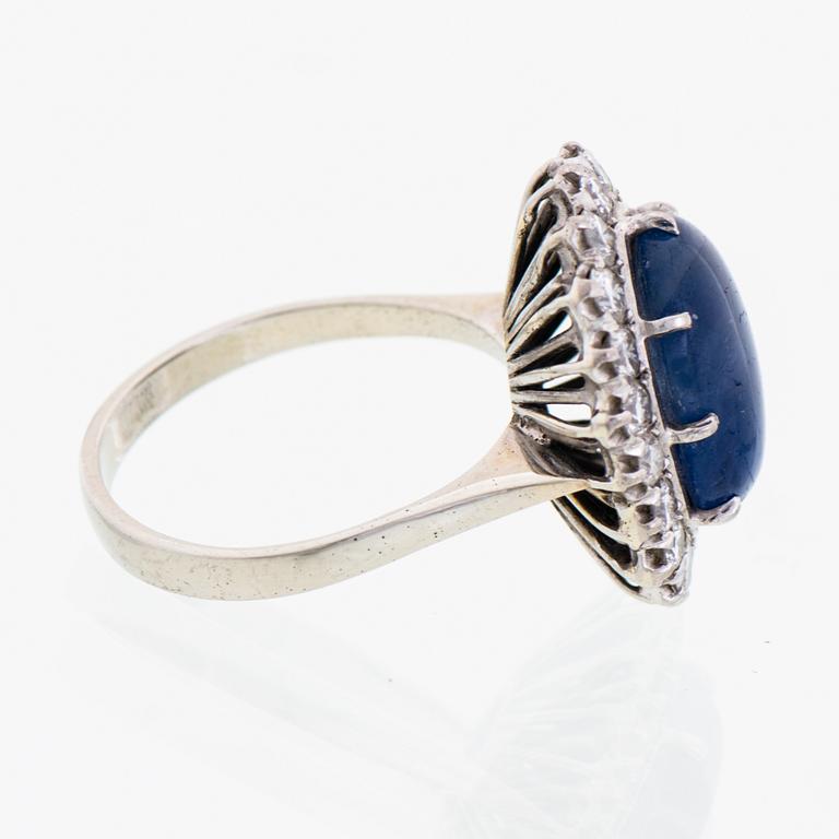 A RING, cabochon cut star sapphire, brilliant cut diamonds, 18K white gold.