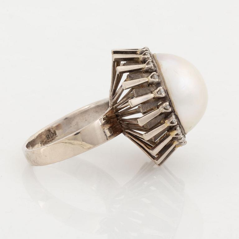 A pearl and diamond ring.