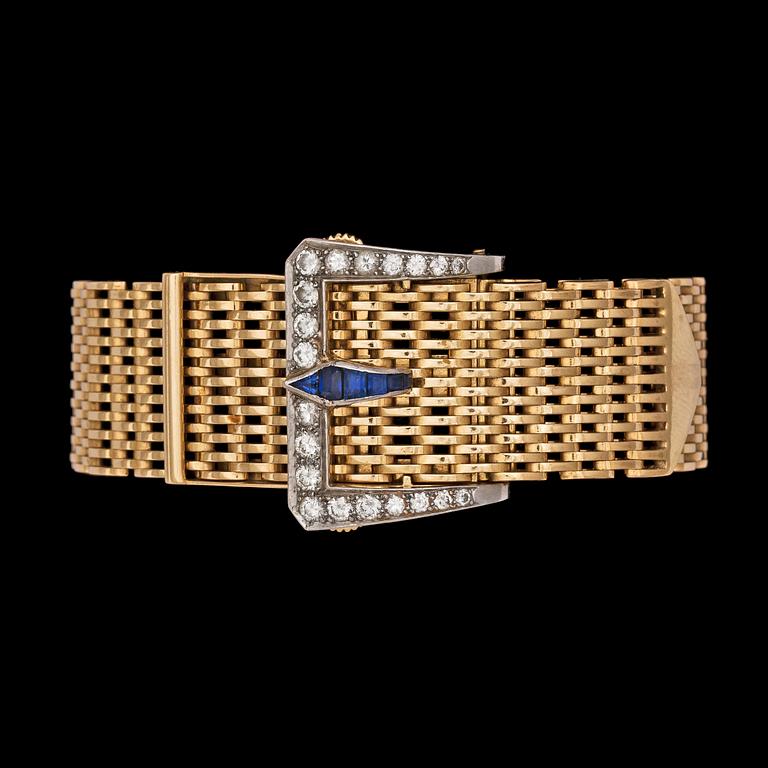 A gold bracelet with diamond and blue sapphire clasp.