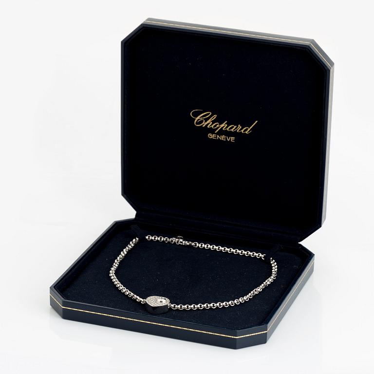 An 18K white gold Chopard "Happy Diamonds" necklace set with round brilliant-cut diamonds.