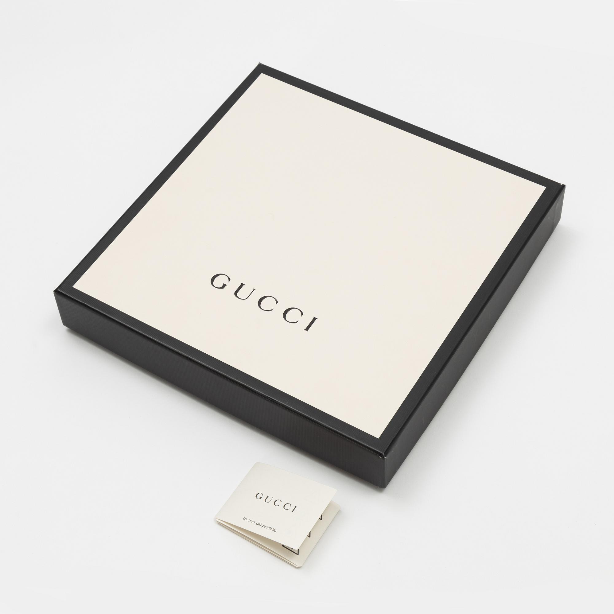 Gucci, a wool and silk mix "GG" jaquard shawl.