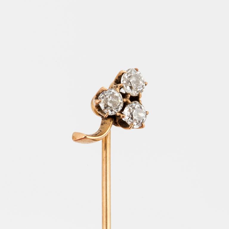 A TIE-PIN, 14K gold with three old cut diamonds.
