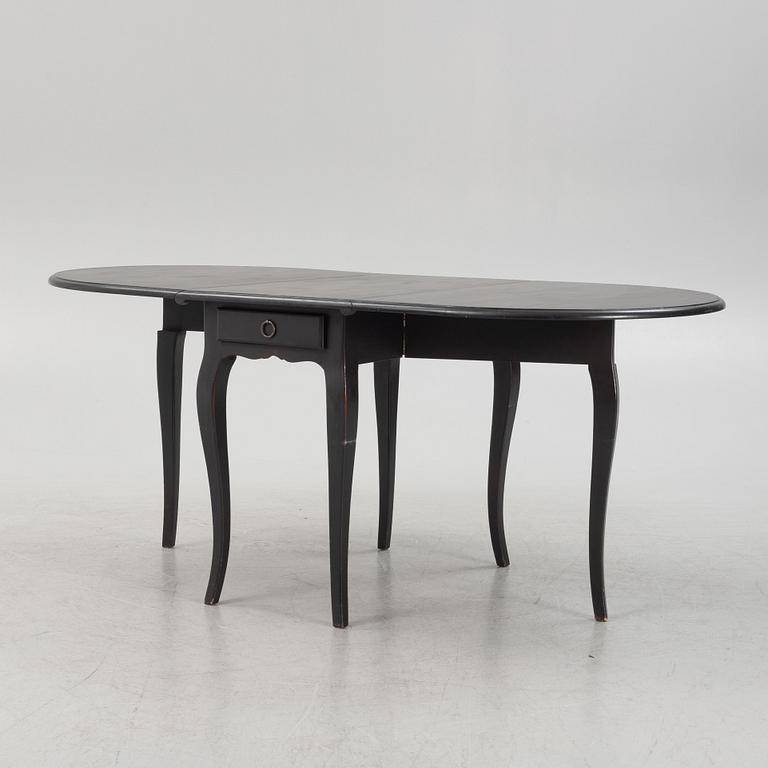 A contemporary painted drop-leaf table.
