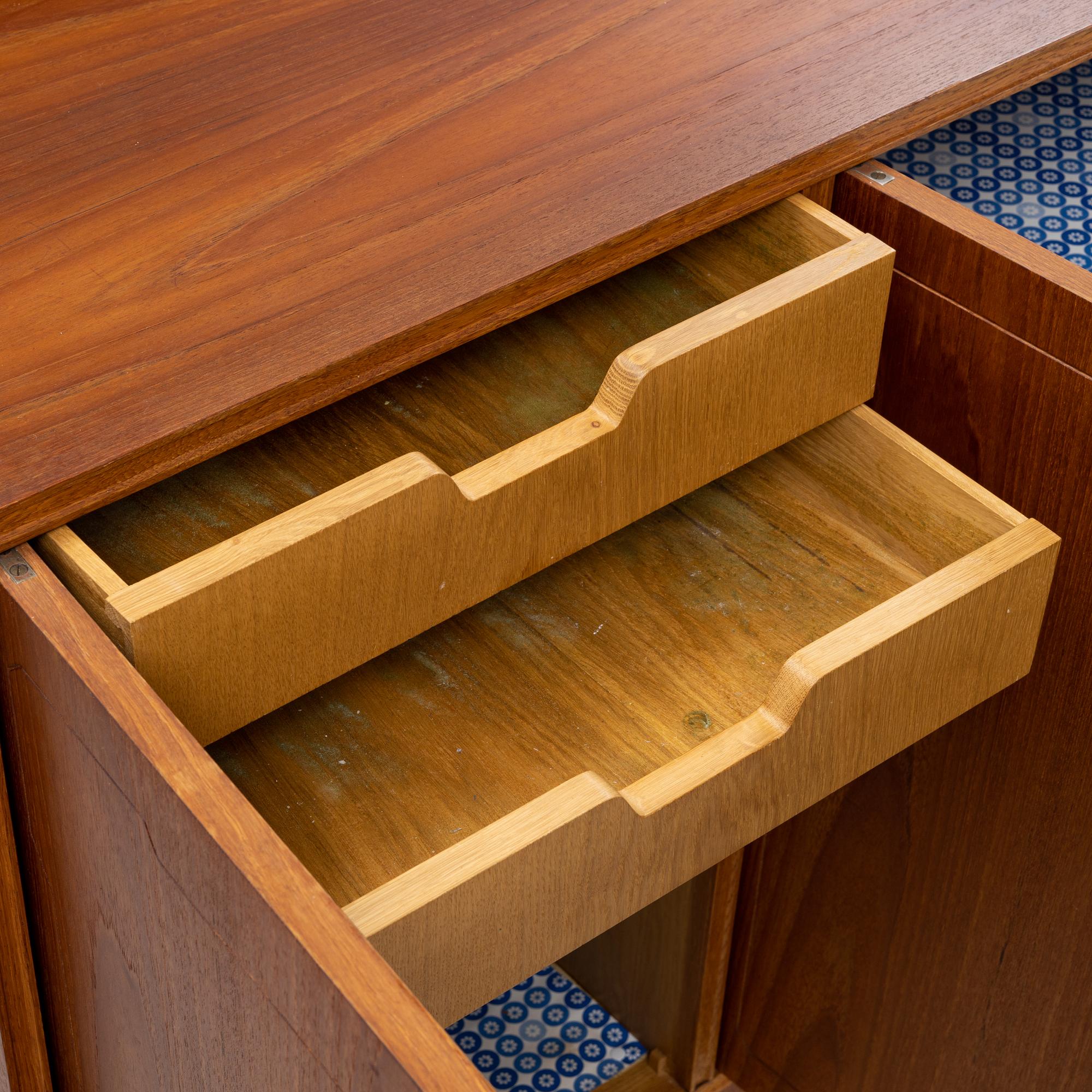 A teak-veneered mid 20th century sideboard.