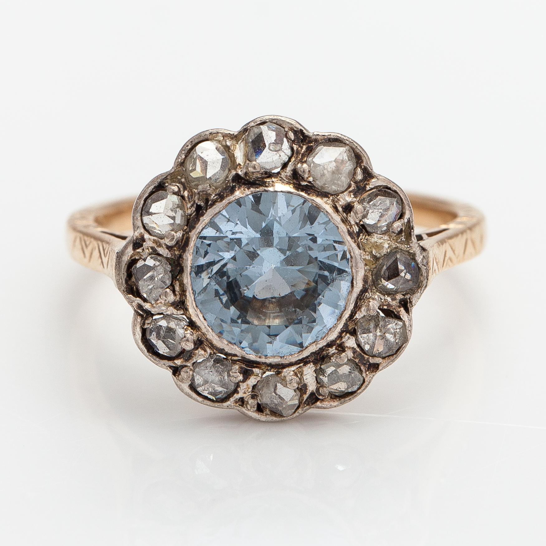 A 13-14K gold ring with a synthetic spinelle and rose-cut dimaonds.