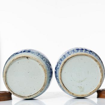 A pair of Chinese blue and white porcealin jars with wooden covers, Qing dynasty, 19th Century.