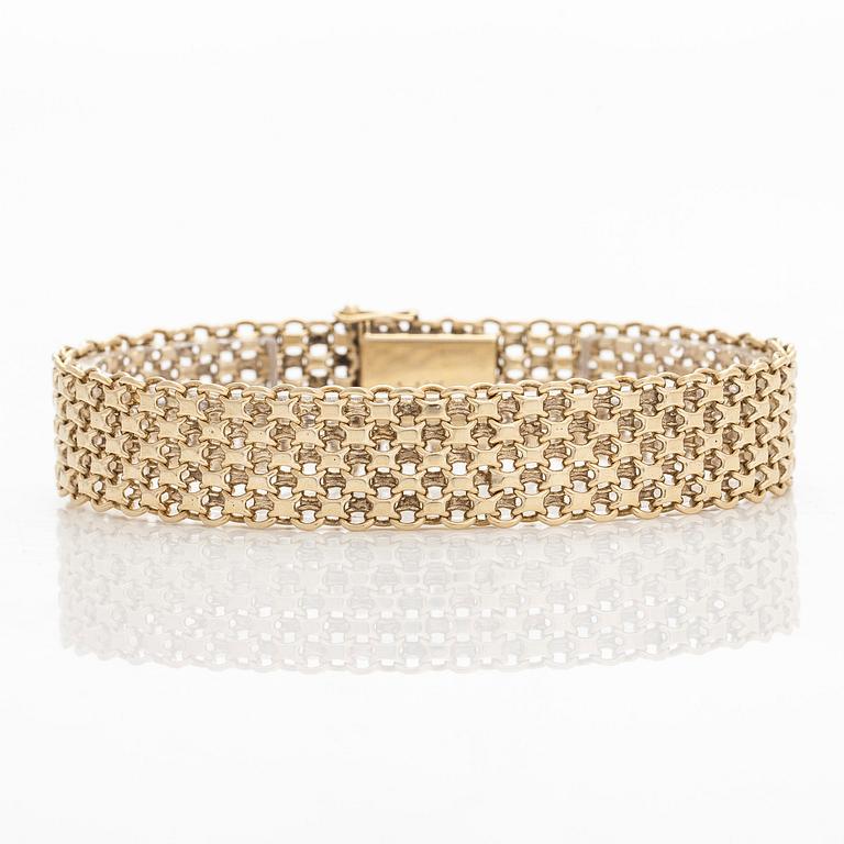 A 14K gold X-link bracelet, likely Norway.