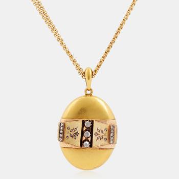 An 18K gold locket set with rose-cut diamonds.