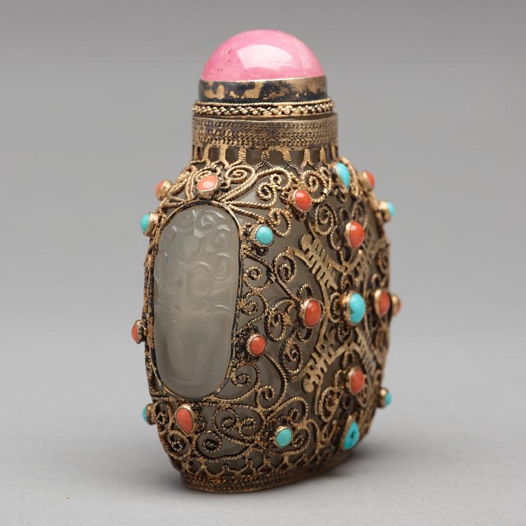 Three nephrite and agathe snuff bottles with stoppers, China and Tibet, late 19th Century.