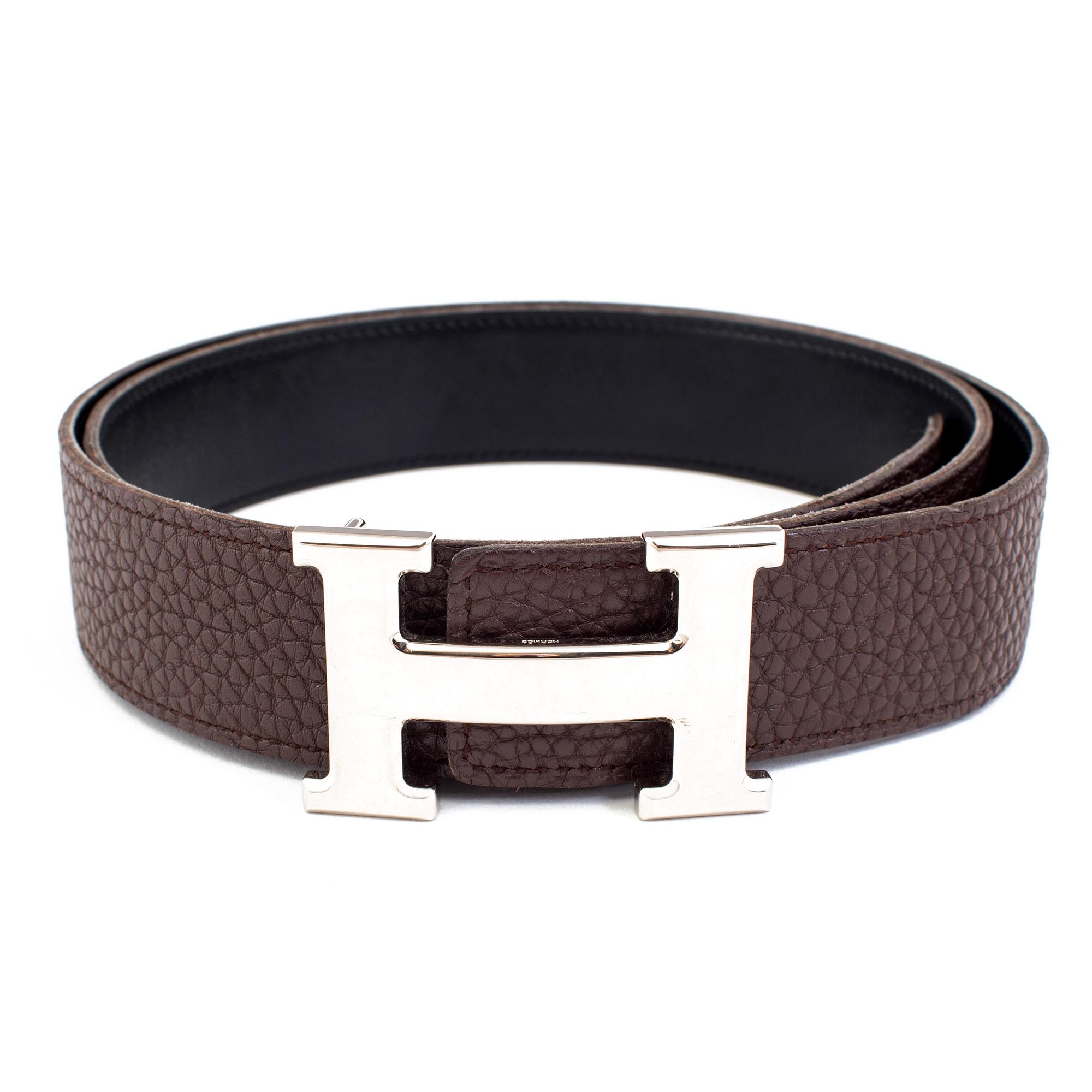 Brown togo belt "Constance" by Hermès.