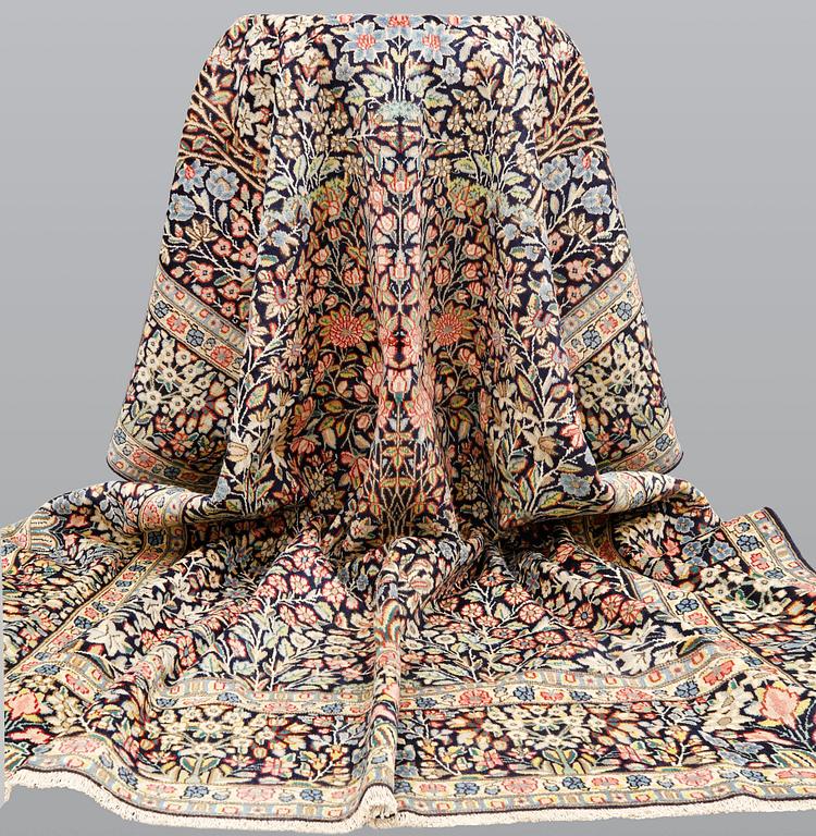 A 'Millefleur' Kerman Laver carpet, c. 410 x 290 cm.