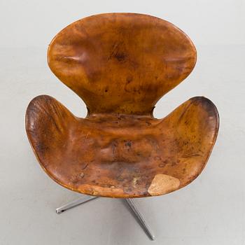 An Arne Jacobsen steel and brown leather 'Swan' chair, Fritz Hansen, Denmark 1960's.