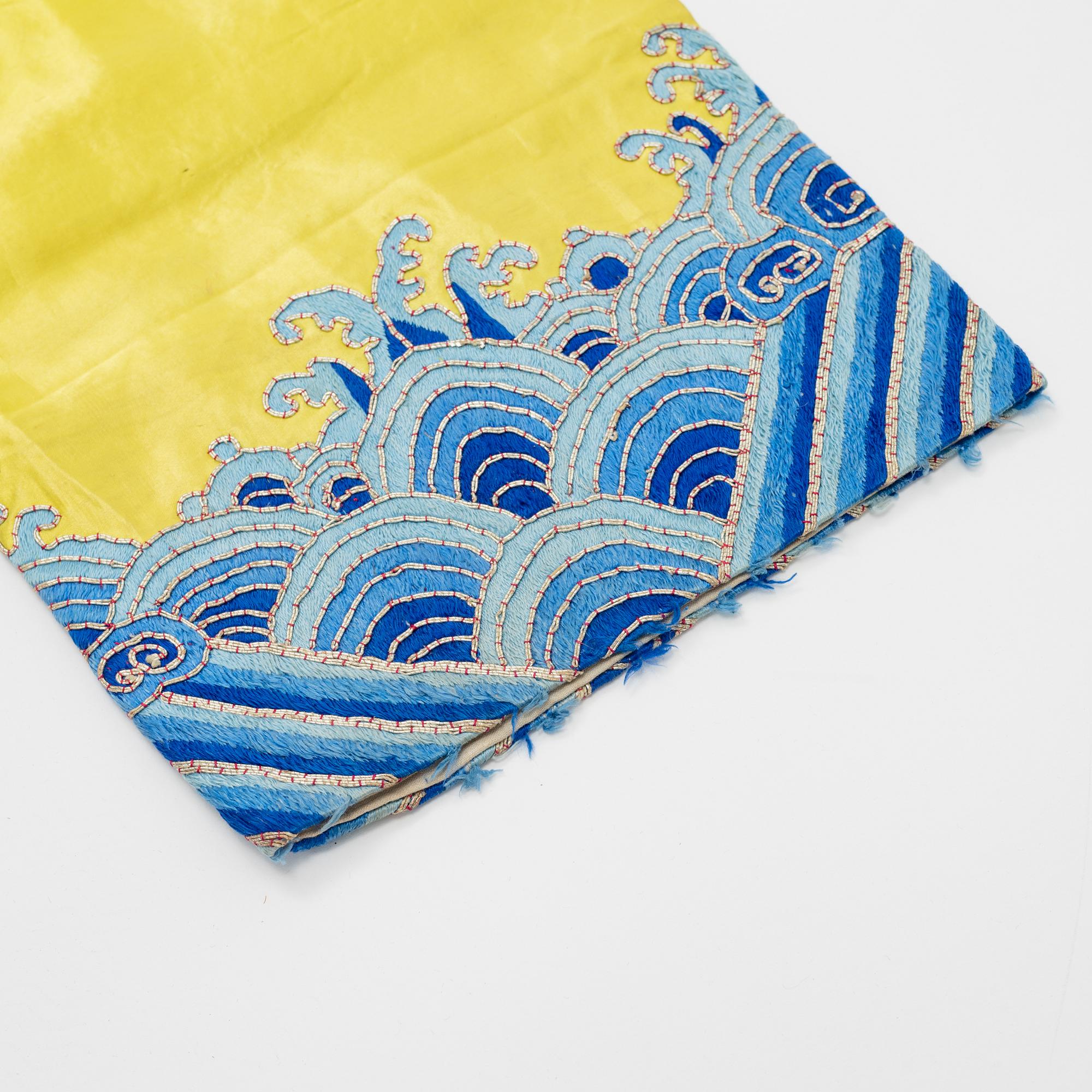 A yellow-ground embroidered silk robe, 20th century.