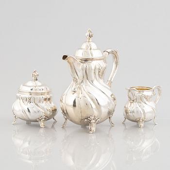 A German Rococo-Style Silver Coffee Pot, Creamer and Sugar Bowl, mark of MH Wilkens & Söhne, Bremen-Hemelingen.