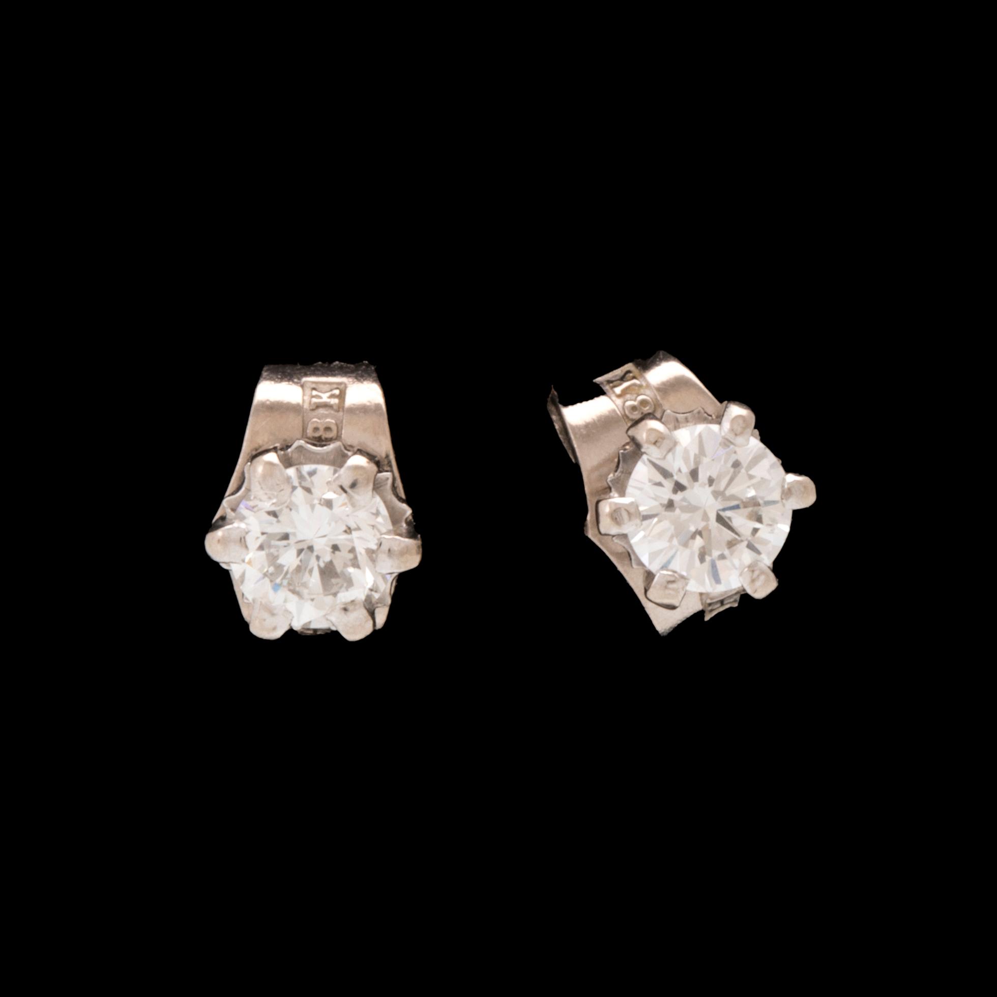 A pair of 18K white gold earrings set with round brilliant cut diamonds.