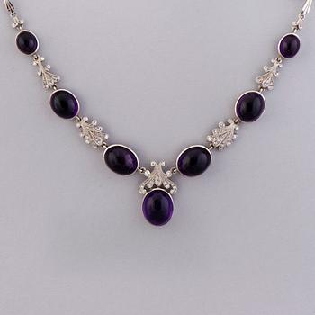 A NECKLACE, BRACELET, EARRINGS and RING, amethysts, diamnonds, 18K white gold and palladium. A. Tillander, 1970s.