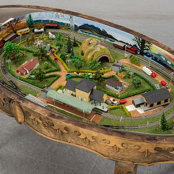 A table with a mini-trix modeltrain inside.