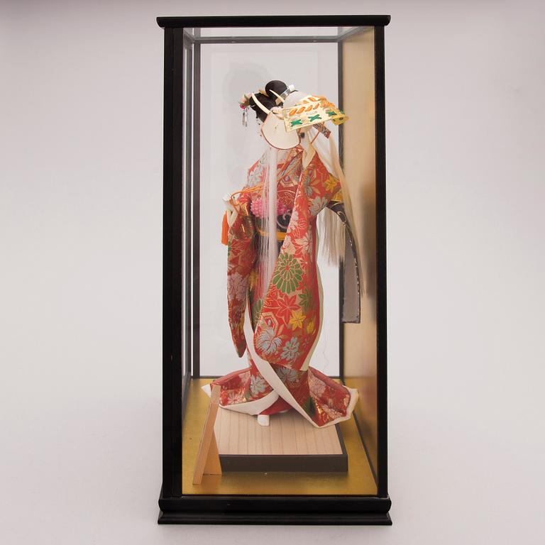 A latter half of the 20th century Japanese doll in showcase.