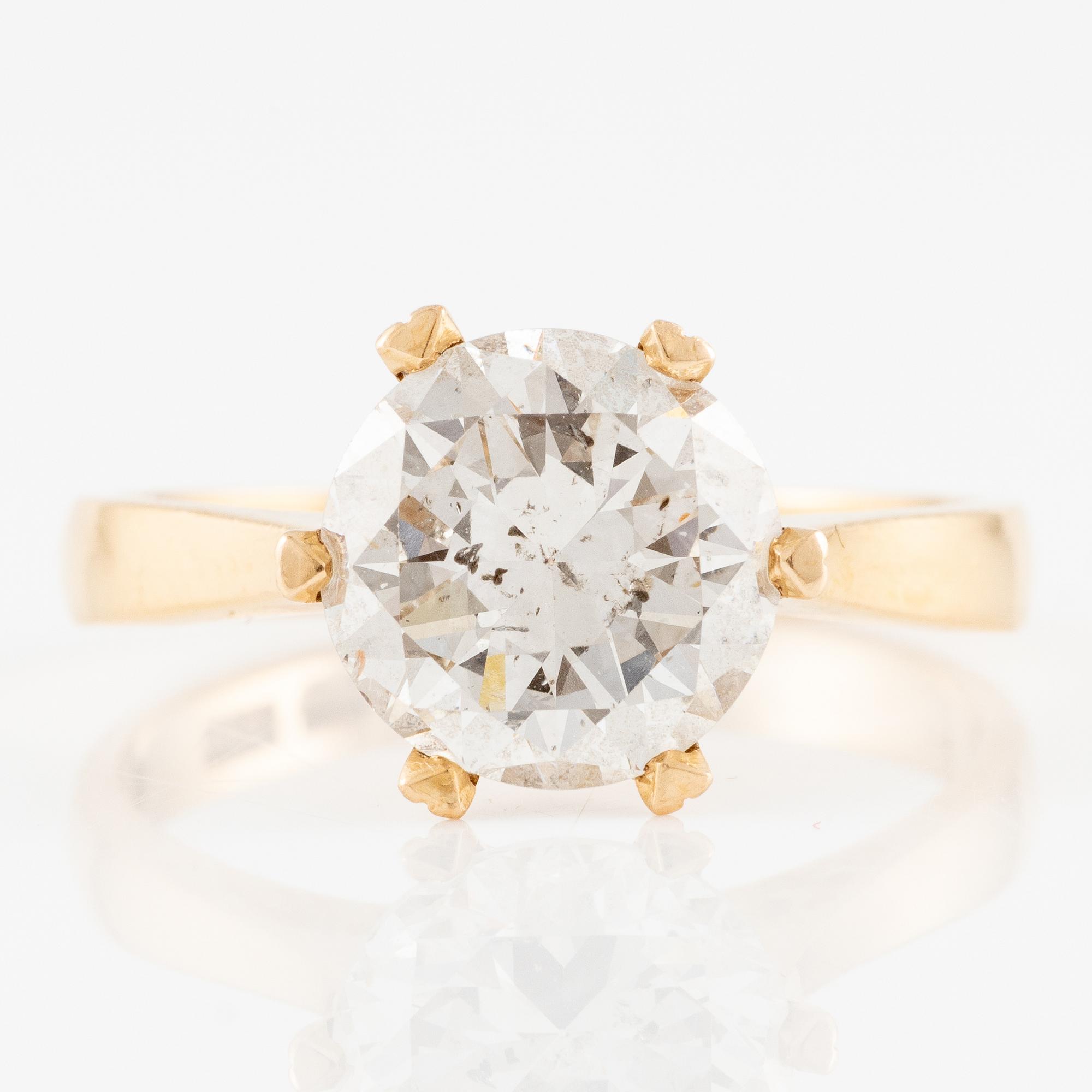 Ring 18K gold with a round brilliant-cut diamond.