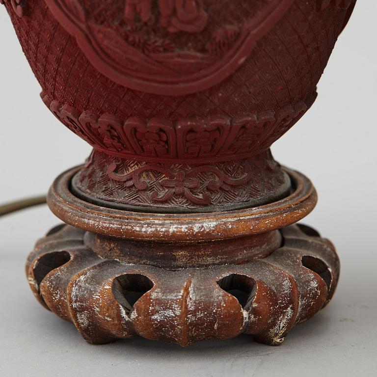 A pair of Chinese red lacquered vases, turned into table lamps, 20th century.