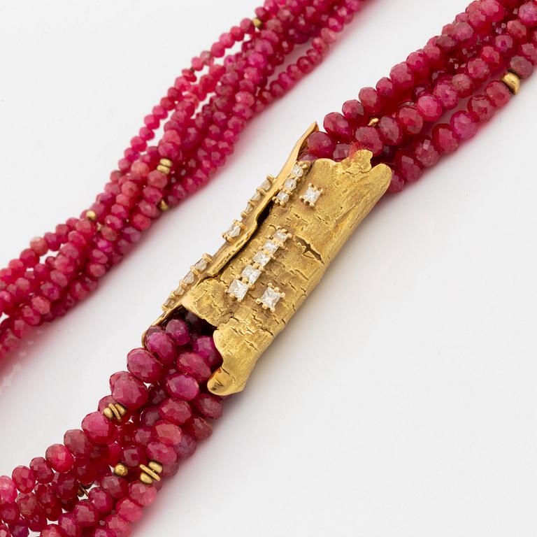 A W Nussberger ruby necklace with an 18K gold clasp set with princess-cut diamonds.