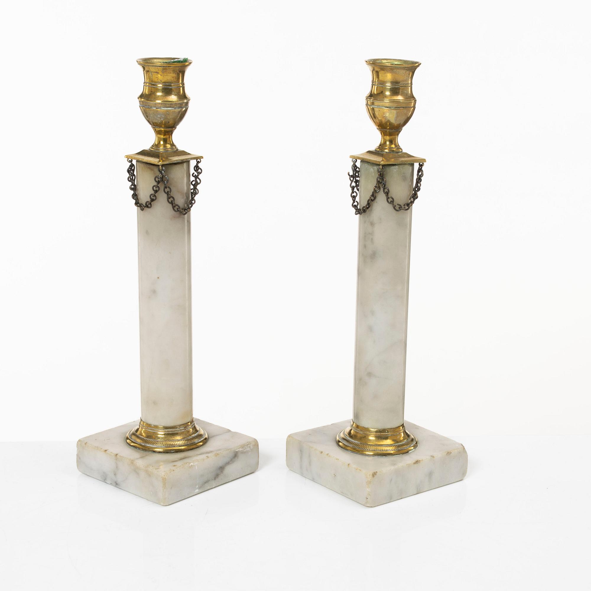 A pair of Gustavian brass and marble candlesticks, circa 1800.