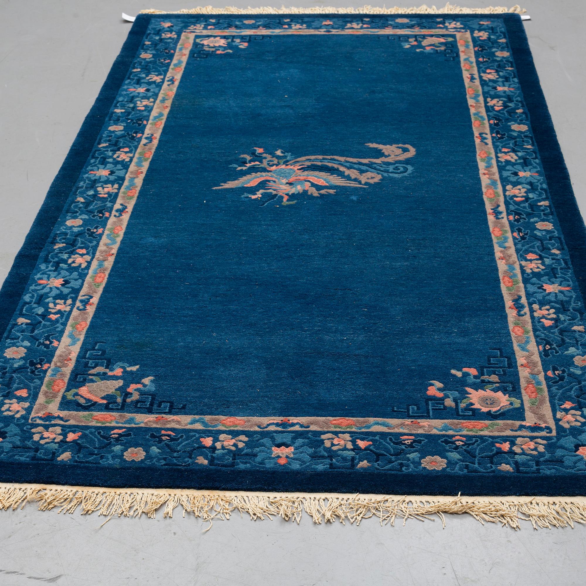 A CARPET, an old China, ca 295 x 153 cm (as well as 2 cm flat weave at the ends).