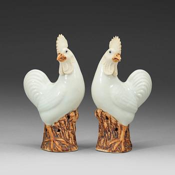 249. A pair of white and brown glazed figures of roosters, late Qing dynasty,