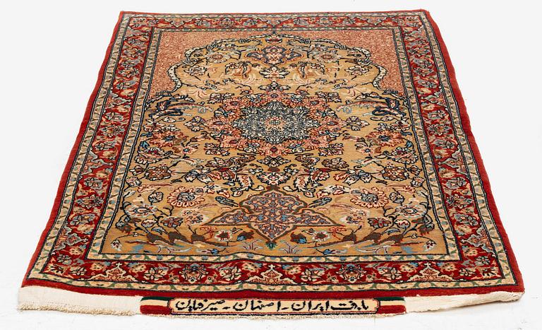 A semi-antique Isfahan rug, central Iran, part silk, signed (Mohammed) Seirafian, c. 120 x 70 cm.