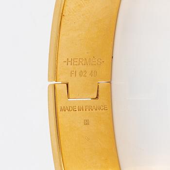 Hermès, a 'Clic H PM' bracelet.