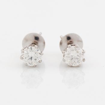 A pair of 18K white gold earrings set with round brilliant-cut diamonds.