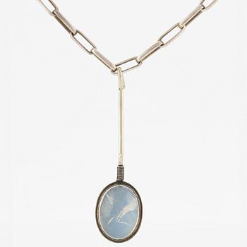 Pendant with silver chain and blue stone, likely moonstone.