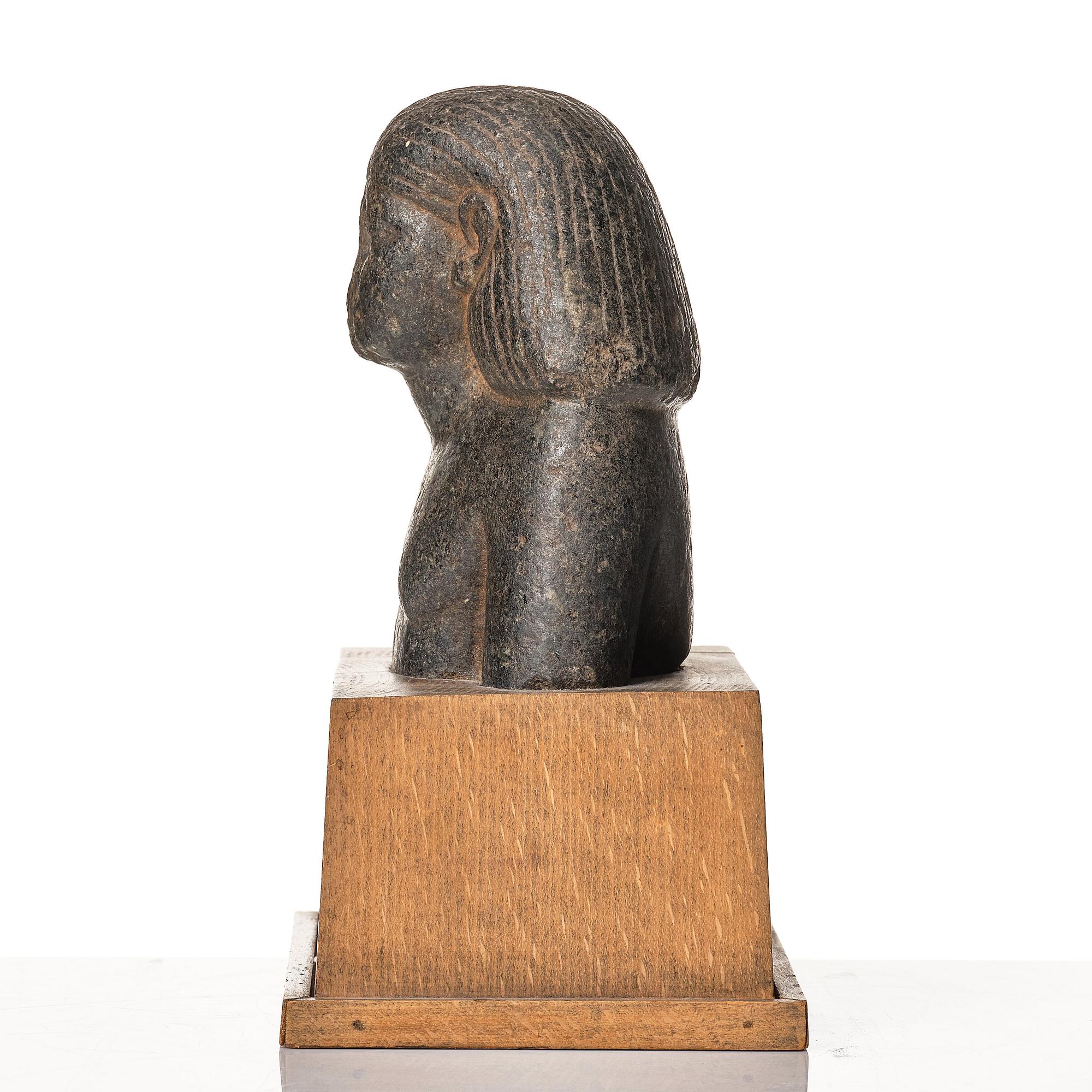 An Egyptian granite bust of an official, Middle Kingdom ca 1900 B.C.