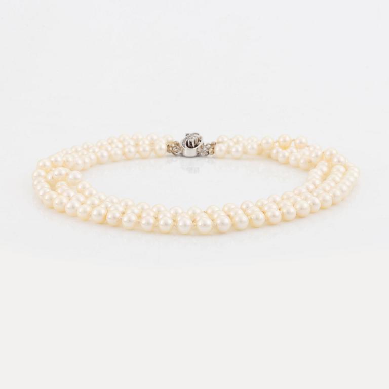 Three strand cultured pearl necklace, clasp with diamonds.