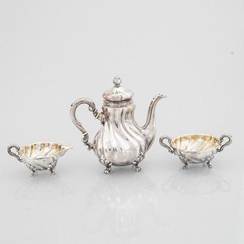 A Rococo Style Silver Coffee Pot, Creamer and Sugar Bowl, 20th Century, Swedish import mark.