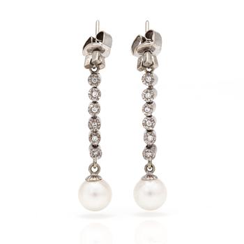 A pair of earrings with cultured pearls and eight-cut diamonds.