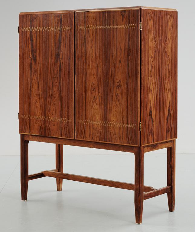 A Carl-Axel Acking palisander cabinet, Nordiska Kompaniet (NK) 1940's-50's.