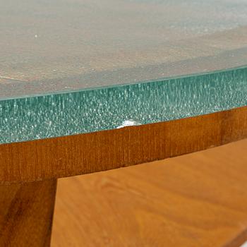A Swedish Modern coffee table with a glass top. 1940's.